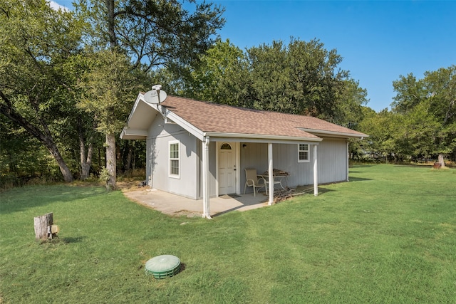 view of side of property with a yard and a patio