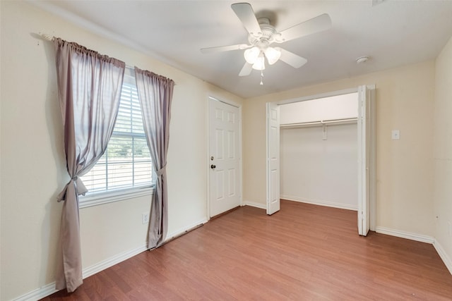 unfurnished bedroom with light hardwood / wood-style flooring, a closet, and ceiling fan