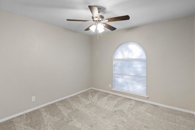 carpeted empty room featuring ceiling fan