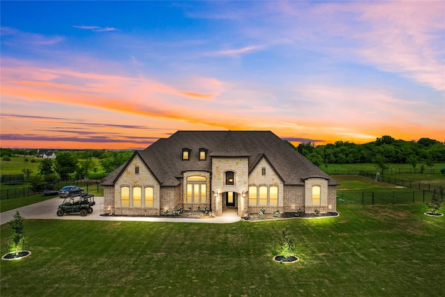 french country style house with a yard