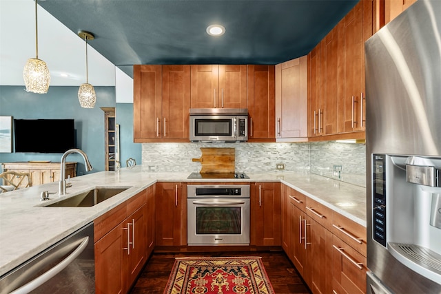 kitchen with sink, dark hardwood / wood-style flooring, decorative light fixtures, decorative backsplash, and appliances with stainless steel finishes