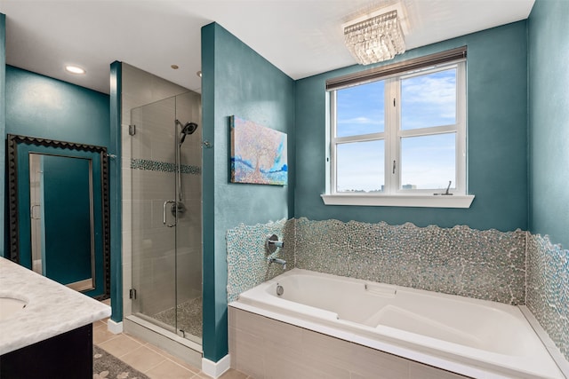 bathroom featuring tile patterned flooring, vanity, plus walk in shower, and a notable chandelier