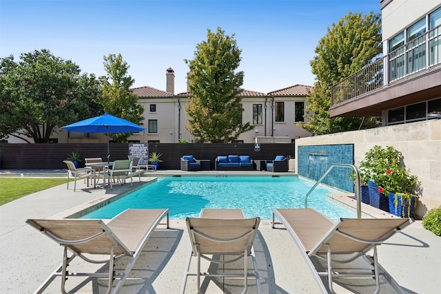 view of swimming pool featuring pool water feature, a patio area, and an outdoor hangout area