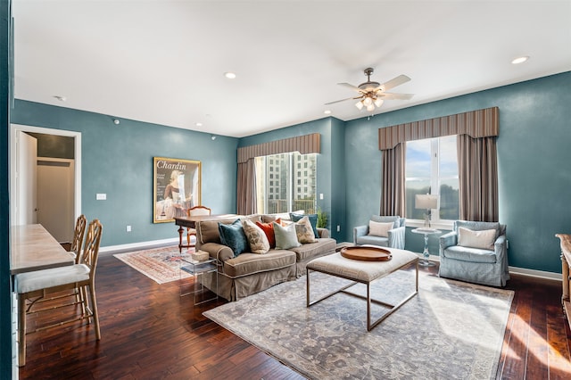 living room featuring dark hardwood / wood-style floors and ceiling fan