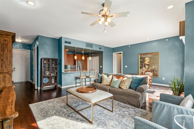 living room with ceiling fan and dark wood-type flooring