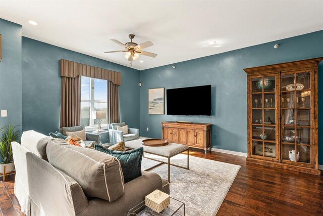 living room featuring dark hardwood / wood-style floors and ceiling fan