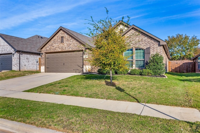 view of front of house featuring a garage and a front lawn