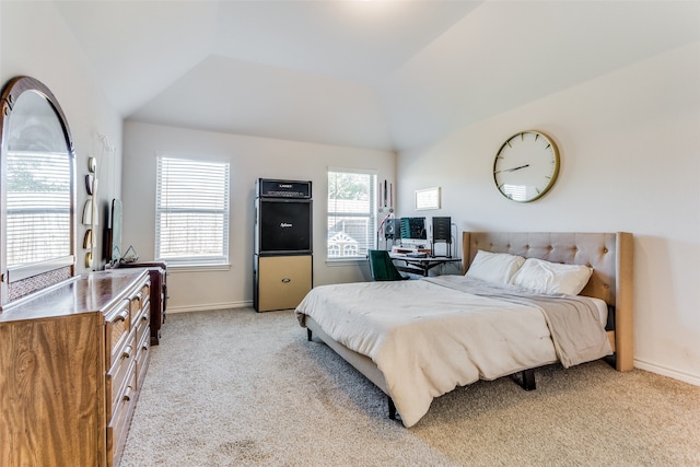 carpeted bedroom with lofted ceiling