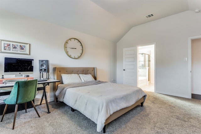 bedroom featuring vaulted ceiling, carpet floors, and ensuite bathroom