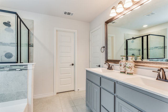 bathroom featuring vanity, a shower with shower door, and tile patterned floors