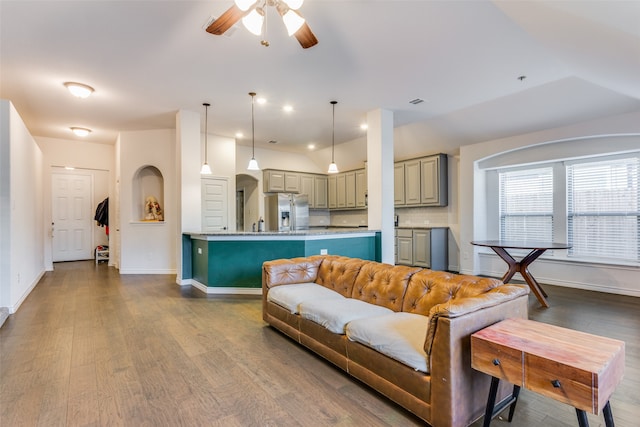 living room with vaulted ceiling, hardwood / wood-style floors, and ceiling fan