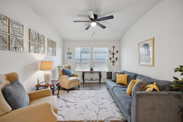 living room with light hardwood / wood-style floors, vaulted ceiling, and ceiling fan