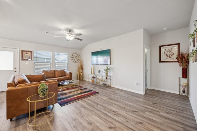 living room with hardwood / wood-style floors, ceiling fan, and lofted ceiling