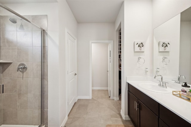 bathroom with tile patterned flooring, vanity, and an enclosed shower