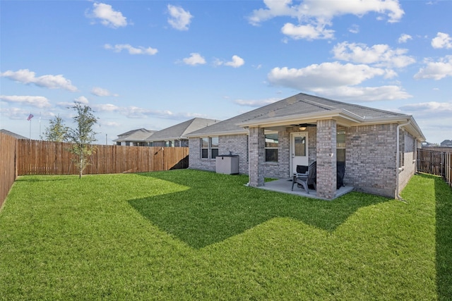 back of house featuring a lawn and a patio