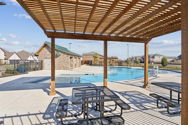 view of pool with a patio and a pergola