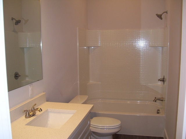 full bathroom featuring shower / bathing tub combination, vanity, and toilet