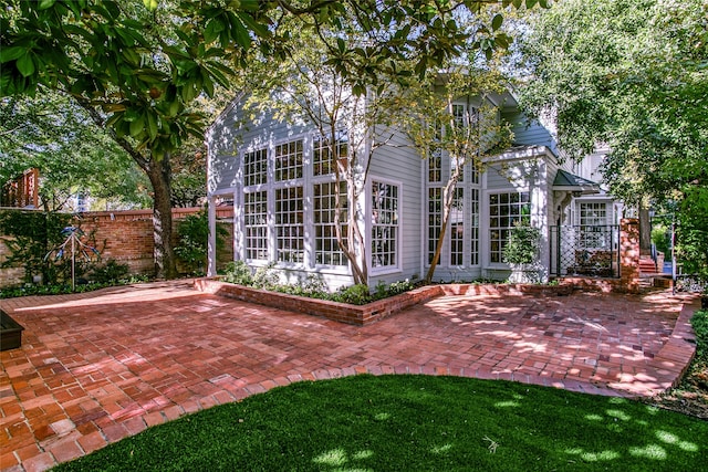 back of property with a patio