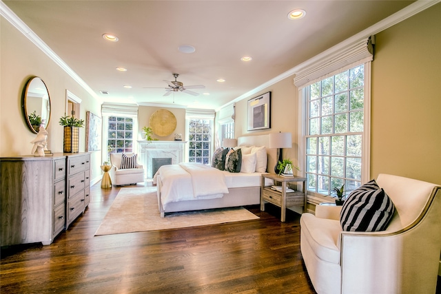 bedroom featuring crown molding, multiple windows, dark wood-type flooring, and ceiling fan