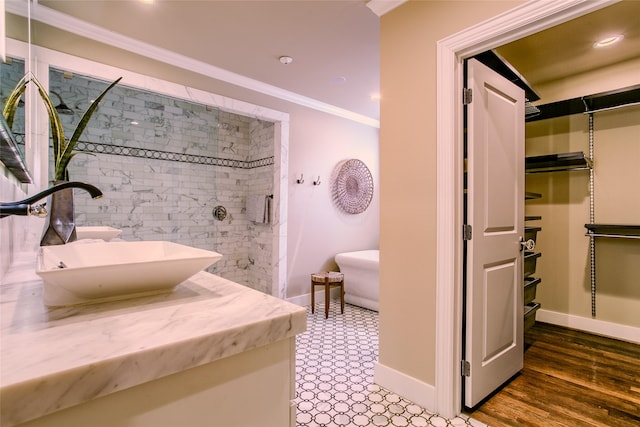 bathroom with hardwood / wood-style floors, vanity, and ornamental molding