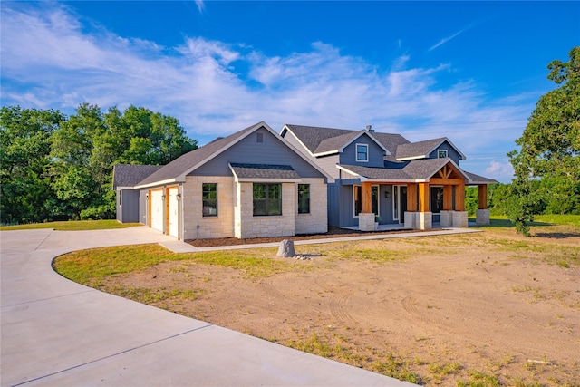 view of front of home featuring covered porch and a garage