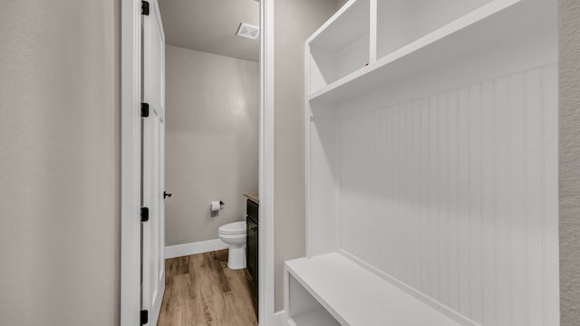 bathroom featuring hardwood / wood-style floors and toilet