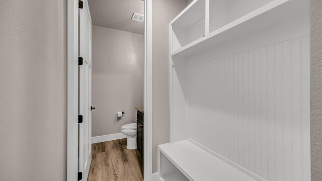 laundry room with washing machine and clothes dryer, sink, cabinets, and light wood-type flooring