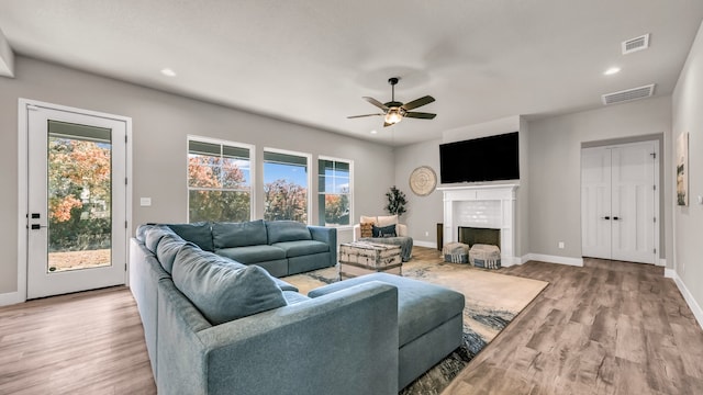 living room featuring ceiling fan and light wood-type flooring