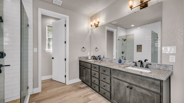 bathroom featuring hardwood / wood-style floors, vanity, and an enclosed shower