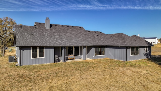 rear view of property with a patio area, a yard, and cooling unit