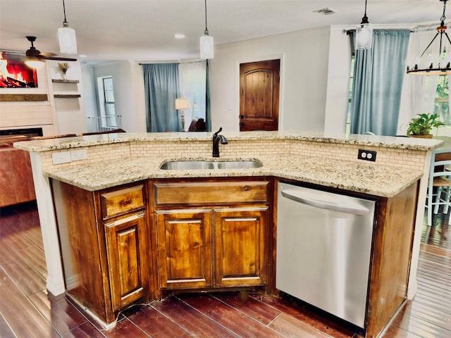 kitchen featuring sink, decorative light fixtures, dishwasher, dark hardwood / wood-style floors, and a kitchen island with sink