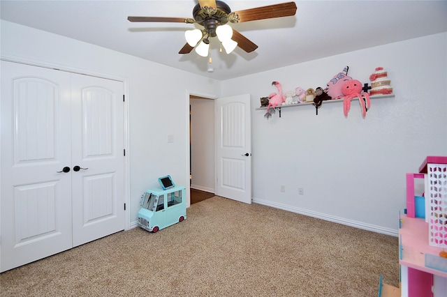 carpeted bedroom featuring ceiling fan and a closet