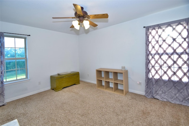 unfurnished room featuring ceiling fan and light carpet