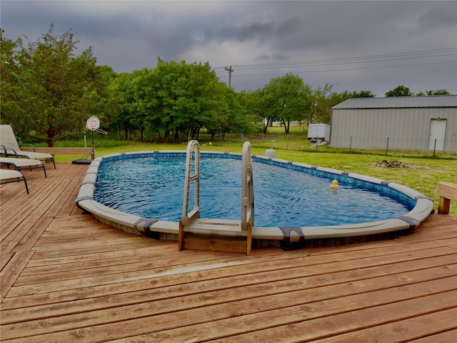 view of swimming pool featuring a yard and a wooden deck