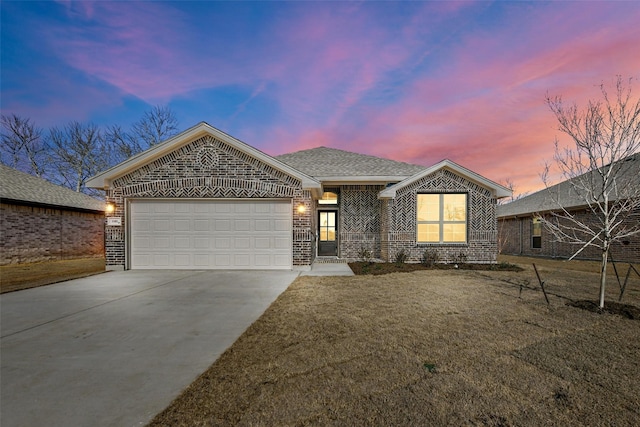 view of front of property featuring a garage, concrete driveway, brick siding, and roof with shingles