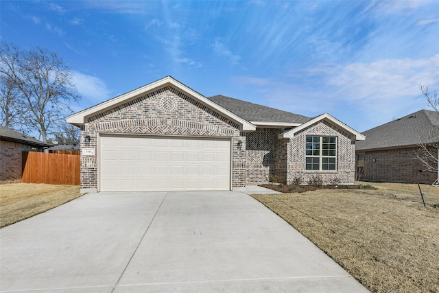 view of front of house with concrete driveway, brick siding, an attached garage, and fence