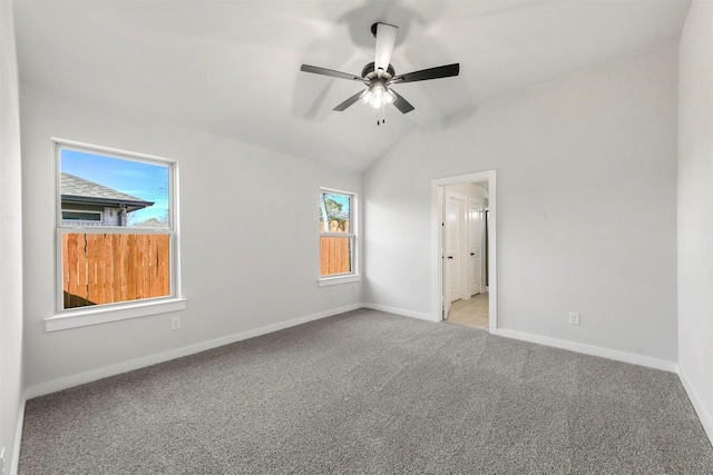 unfurnished bedroom with light carpet, baseboards, a ceiling fan, and lofted ceiling