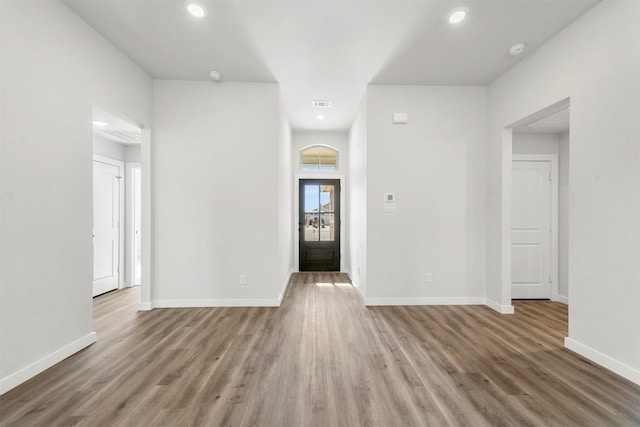 entryway featuring baseboards, wood finished floors, and recessed lighting