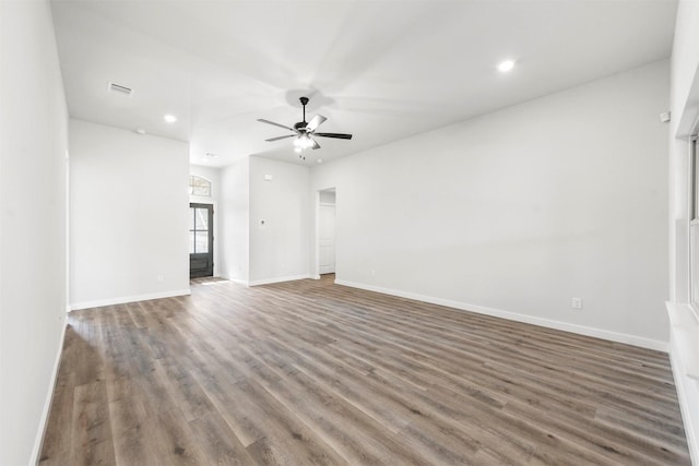 unfurnished living room featuring baseboards, visible vents, ceiling fan, and wood finished floors