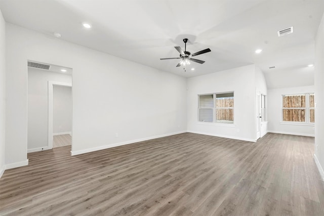 unfurnished living room featuring visible vents, baseboards, and wood finished floors