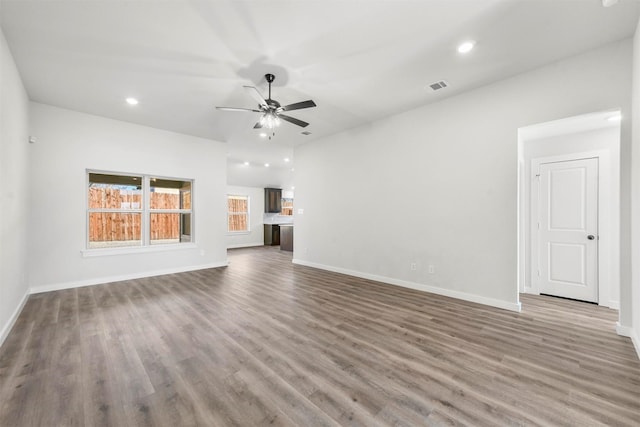 unfurnished living room with recessed lighting, visible vents, a ceiling fan, wood finished floors, and baseboards