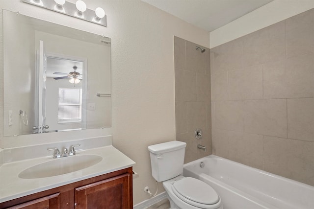 full bathroom featuring vanity, tiled shower / bath combo, and toilet