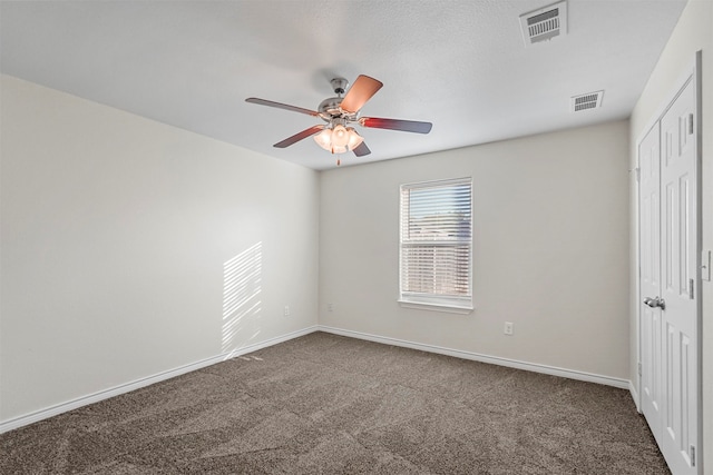 carpeted spare room featuring ceiling fan