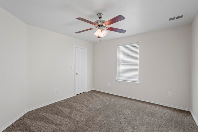 carpeted spare room featuring ceiling fan