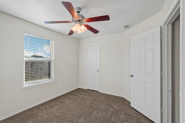 unfurnished bedroom featuring a closet, ceiling fan, and dark colored carpet