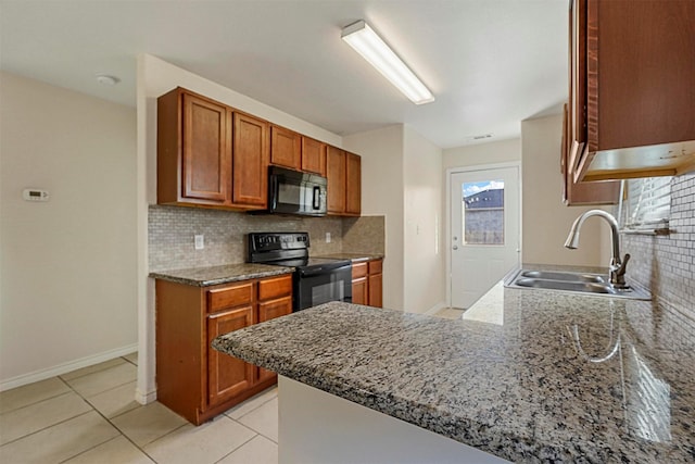 kitchen featuring light tile patterned flooring, black appliances, sink, kitchen peninsula, and light stone countertops