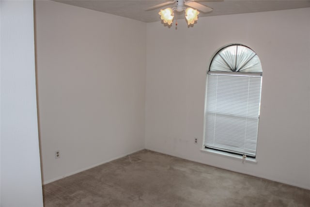 unfurnished room featuring ceiling fan and light carpet