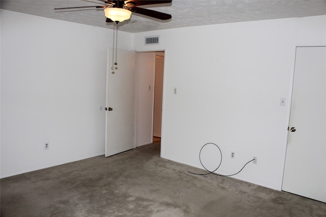 unfurnished room with ceiling fan, carpet floors, and a textured ceiling