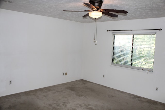 carpeted spare room featuring a textured ceiling and ceiling fan