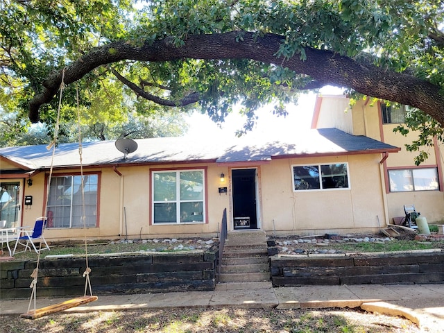 view of side of property featuring central AC unit and a carport